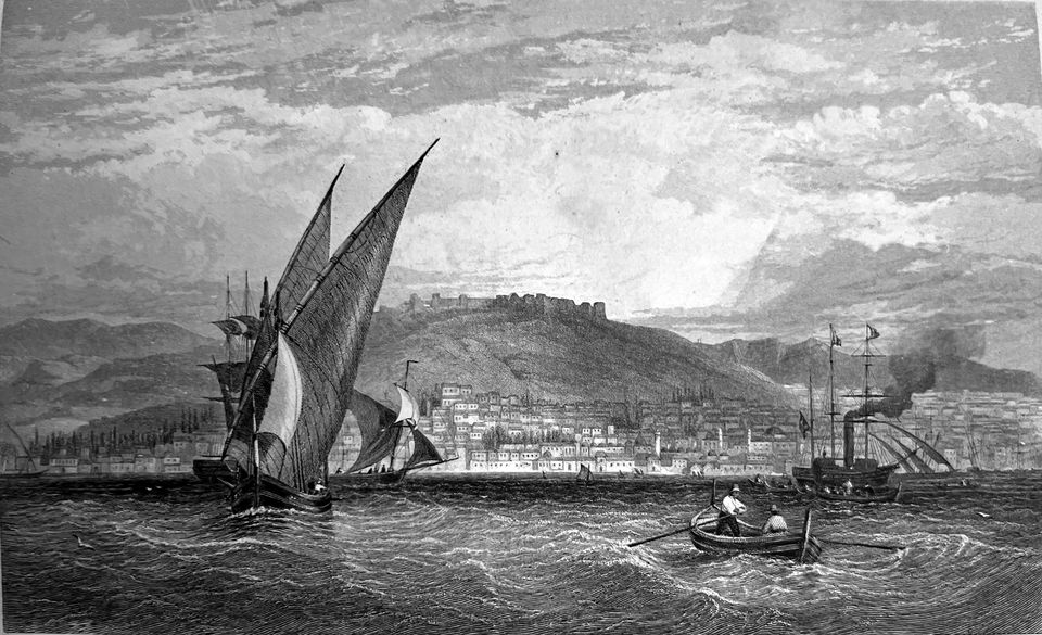 Victorian engraving of sailing ships and a steamer in the harbour at Smyrna, the town and a fortified hill beyond.